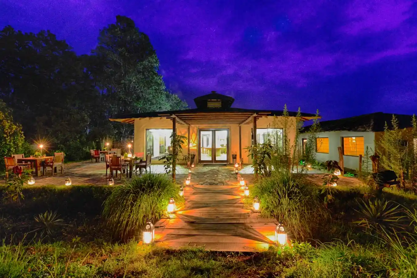 Luxury Resorts in Jim Corbett featuring a beautifully illuminated resort with landscaped gardens and elegant outdoor seating for a premium forest retreat.