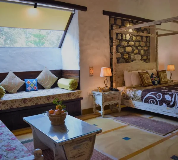 Best resorts in Jim Corbett featuring a luxury suite with elegant interiors, king-size bed, and premium amenities for a comfortable wildlife getaway.