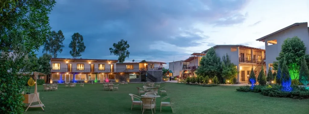 Comfortable resort cottages and garden area at one of the budget resorts in Jim Corbett